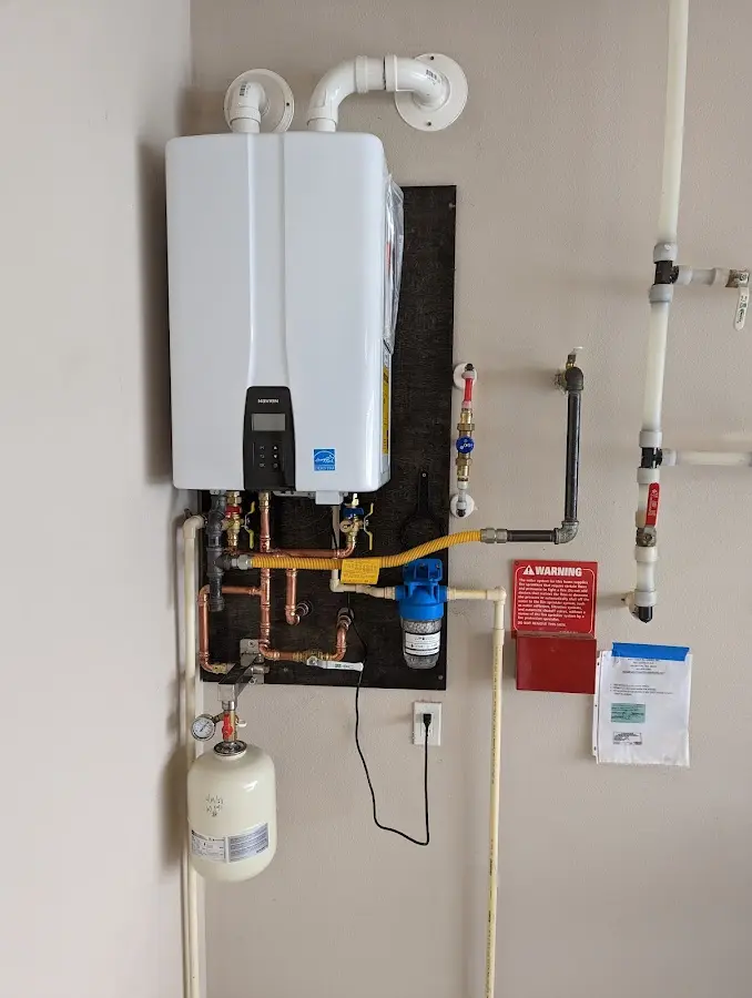 Professional plumber installing copper piping in a Lake of the Woods home